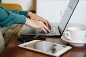 Cellphone, laptops, fingers on laptop